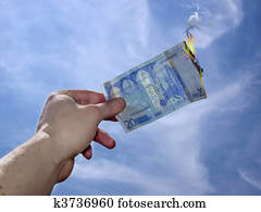 hand taking twenty burning euro