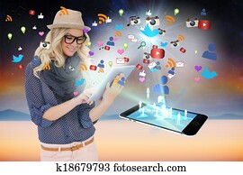 Stylish blonde using tablet pc with app icons and smartphone