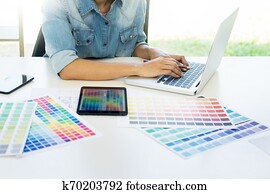interior design or graphic designer renovation and technology concept - woman working with colour samples for selection interior design or graphic designer renovation and technology concept - woman working with colour samples for selection