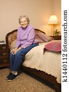 Mature woman on bed.