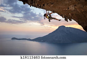 Young female rock climber at sunset Young female rock climber at sunset