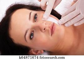 Therapist Waxing Woman's Face Therapist Waxing Woman's Face