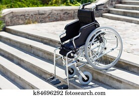 Wheelchair near the steps in a spring park. Wheelchair near the steps in a spring park.
