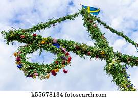 A maypole decorated with flowers.