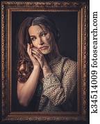 Aging and skin care concept. Half old half young woman with picture frame.