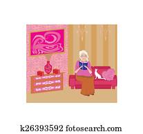 Senior woman in living room reading a book Senior woman in living room reading a book