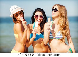 girls in bikini with ice cream on the beach girls in bikini with ice cream on the beach