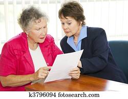 Senior Woman Reading Paperwork Senior Woman Reading Paperwork
