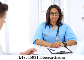 Female african american medical doctor with colleague in hospital