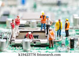 Team of engineers repairing circuit board Team of engineers repairing circuit board