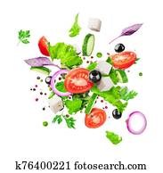 Salad ingredients are flying isolated on a white background. Healthy nutrition Salad ingredients are flying isolated on a white background. Healthy nutrition