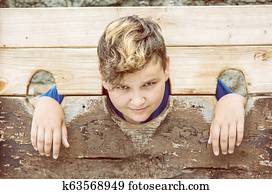 Young caucasian boy in medieval pillory