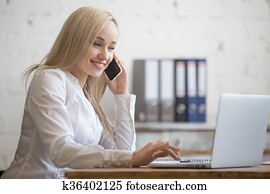 Happy businesswoman working in her office