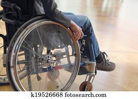 Child in a wheelchair in a gym Child in a wheelchair in a gym