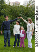 parents playing with children in park