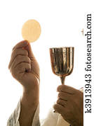 Catholic priest during communion in worship Catholic priest during communion in worship