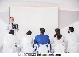 Calm therapeutic showing roentgenogram to his associate