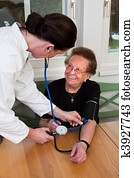Doctor measuring patient blood pressure