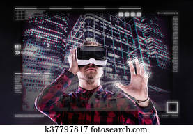 Man wearing virtual reality goggles. Studio shot, black backgrou