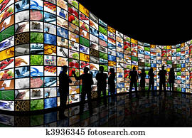 People looking at wall of screens