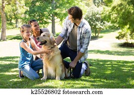 Happy family with their dog in the park Happy family with their dog in the park