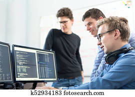 Startup business, software developer working on desktop computer.