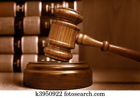 Judges gavel and law books stacked behind Judges gavel and law books stacked behind