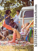 Carefree hipster having fun on campsite