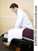 Chiropractor Adjusts Senior Man Chiropractor Adjusts Senior Man