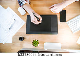 Table of graphic designer using pen tablet with stylus Table of graphic designer using pen tablet with stylus