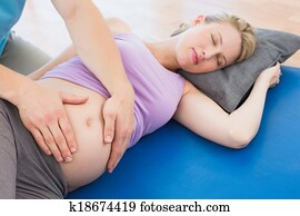 Peaceful pregnant woman having a relaxing massage Peaceful pregnant woman having a relaxing massage