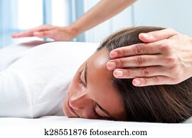 Therapists hands doing reiki therapy on girl. Therapists hands doing reiki therapy on girl.