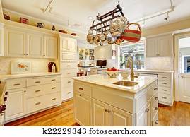 Kitchen room with island and hanging pot rack