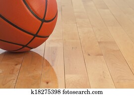 Low angle view of basketball on wooden gym floor 
