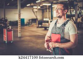 Serviceman in a car workshop Serviceman in a car workshop