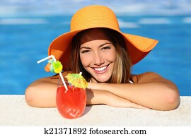 Beauty woman with perfect smile enjoying in a swimming pool on vacations Beauty woman with perfect smile enjoying in a swimming pool on vacations