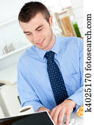 Jolly businessman using a laptop