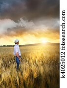Man standing in a field of wheat 