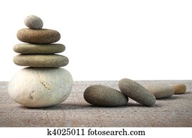 Stack of spa rocks on wood on white