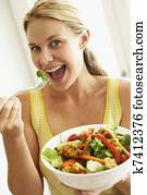 Mid Adult Woman Eating A Healthy Salad