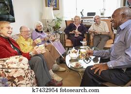 Senior adults having morning tea together