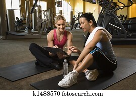 Woman with trainer at gym. Woman with trainer at gym.