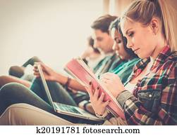 Group of students preparing for exams in apartment interior Group of students preparing for exams in apartment interior
