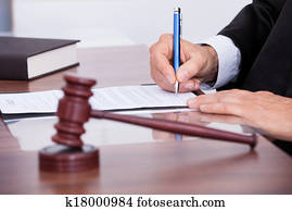 Male Judge Writing On Paper Male Judge Writing On Paper