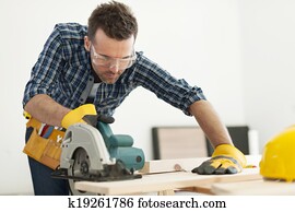 Focus carpenter sawing wood board Focus carpenter sawing wood board