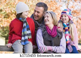 Grandparents with grandchildren outdoors in park smiling (selective focus)