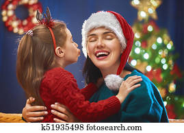 Mom and daughter near the Christmas tree