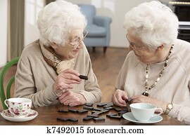 Two Senior Women Playing Dominoes At Day Care Centre