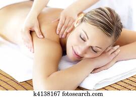 Relaxed smiling woman receiving a back massage