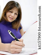 portrait of a young caucasian woman working in a medical office with calendar of appointments